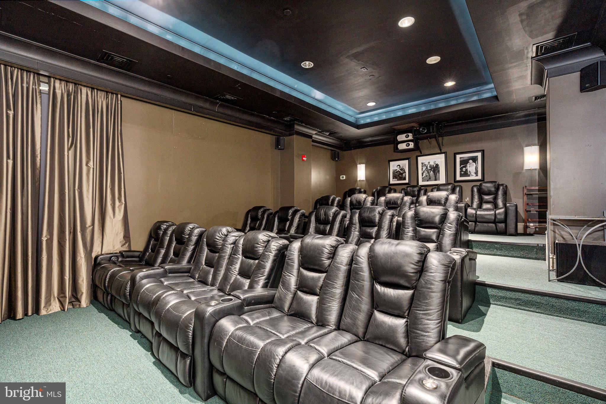 851 North Glebe Road, Unit 1407 Arlington, VA 22203 - Photo 10 of 51 a media room with lots of chairs and a projector