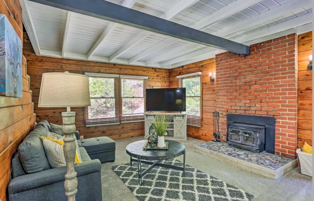 42036 Tollhouse Road Shaver Lake, CA 93664 - Photo 9 of 30 a living room with furniture a flat screen tv and a fireplace