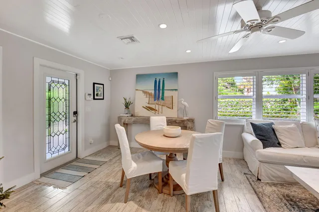 a view of a dining room with furniture window and wooden floor
