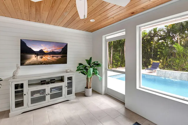 an aerial view of residential houses with outdoor space and trees