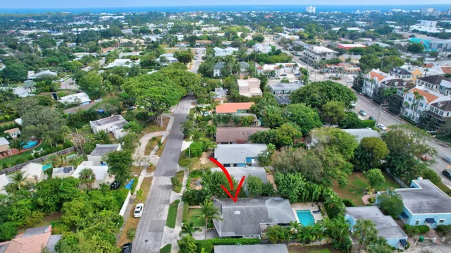 a front view of a house with a garden and plants