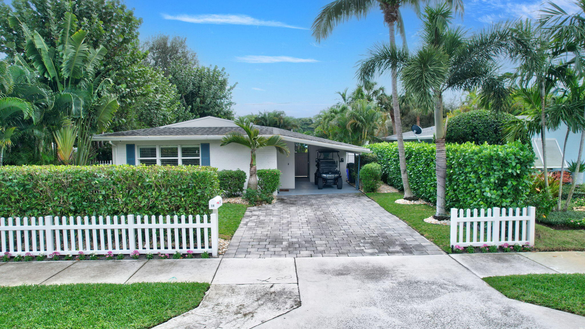 14 Northeast 5th Street Delray Beach, FL 33444 - Photo 42 of 51 a front view of a house with a garden and plants