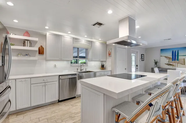 a kitchen with a stove a sink and a refrigerator