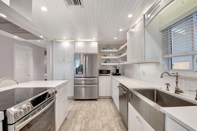 a kitchen with a sink stainless steel appliances and cabinets