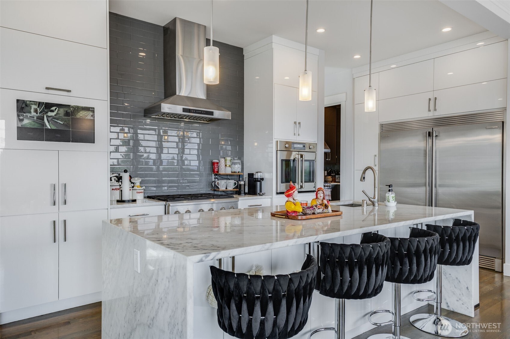 17323 Military Road South SeaTac, WA 98188 - Photo 13 of 40 a kitchen with stainless steel appliances kitchen island granite countertop a sink refrigerator and cabinets