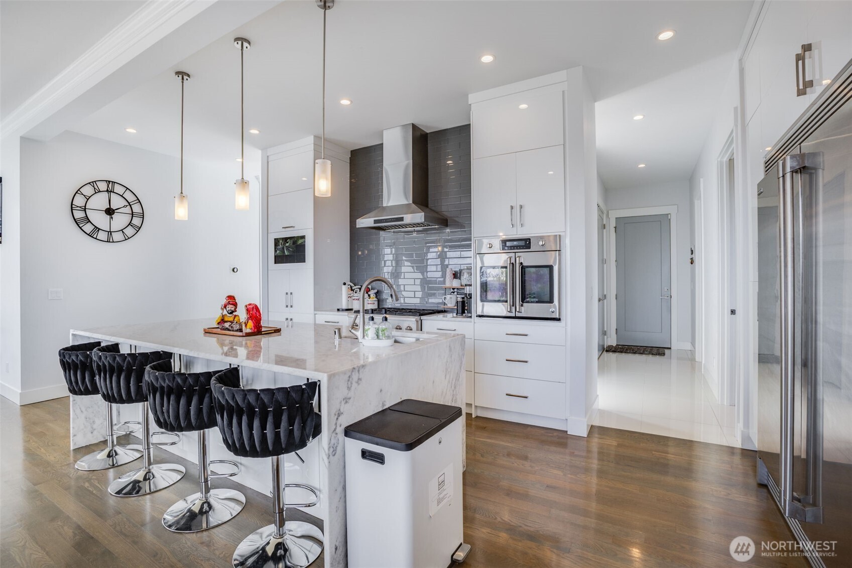 17323 Military Road South SeaTac, WA 98188 - Photo 14 of 40 a kitchen with stainless steel appliances kitchen island granite countertop a table chairs and a refrigerator
