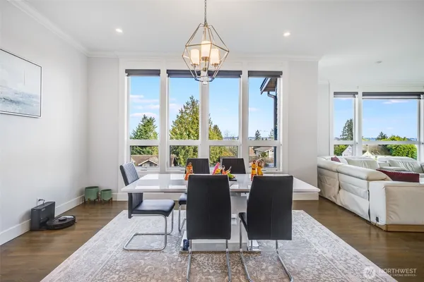 a dining room with furniture a chandelier and wooden floor