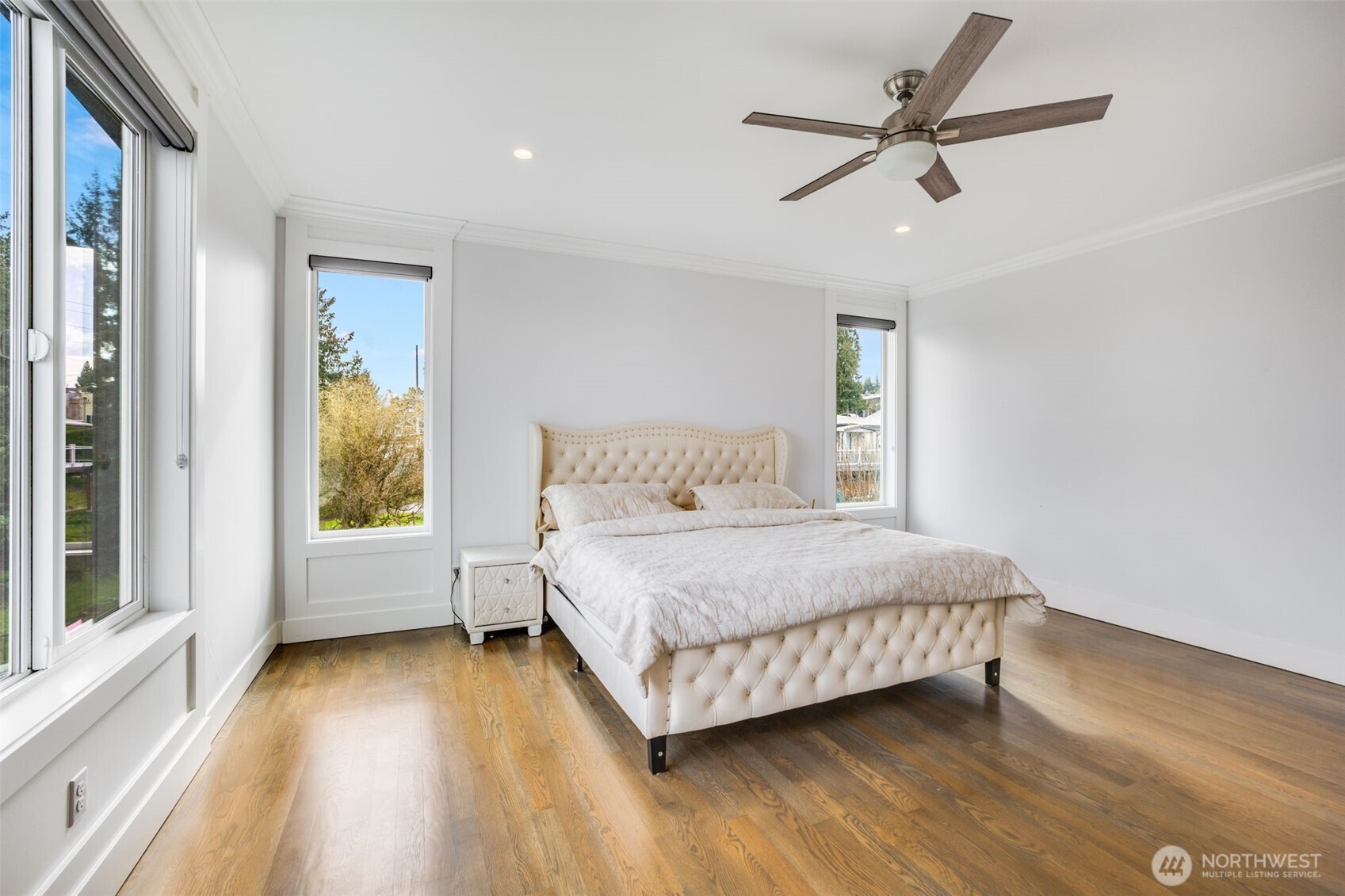 17323 Military Road South SeaTac, WA 98188 - Photo 21 of 40 a bedroom with a large bed chandelier and a window