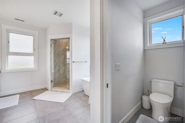 a bathroom with a toilet and a shower