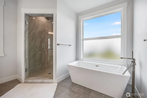 a bathroom with a bathtub and a shower