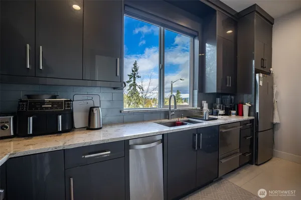 a kitchen with a sink stove and cabinets
