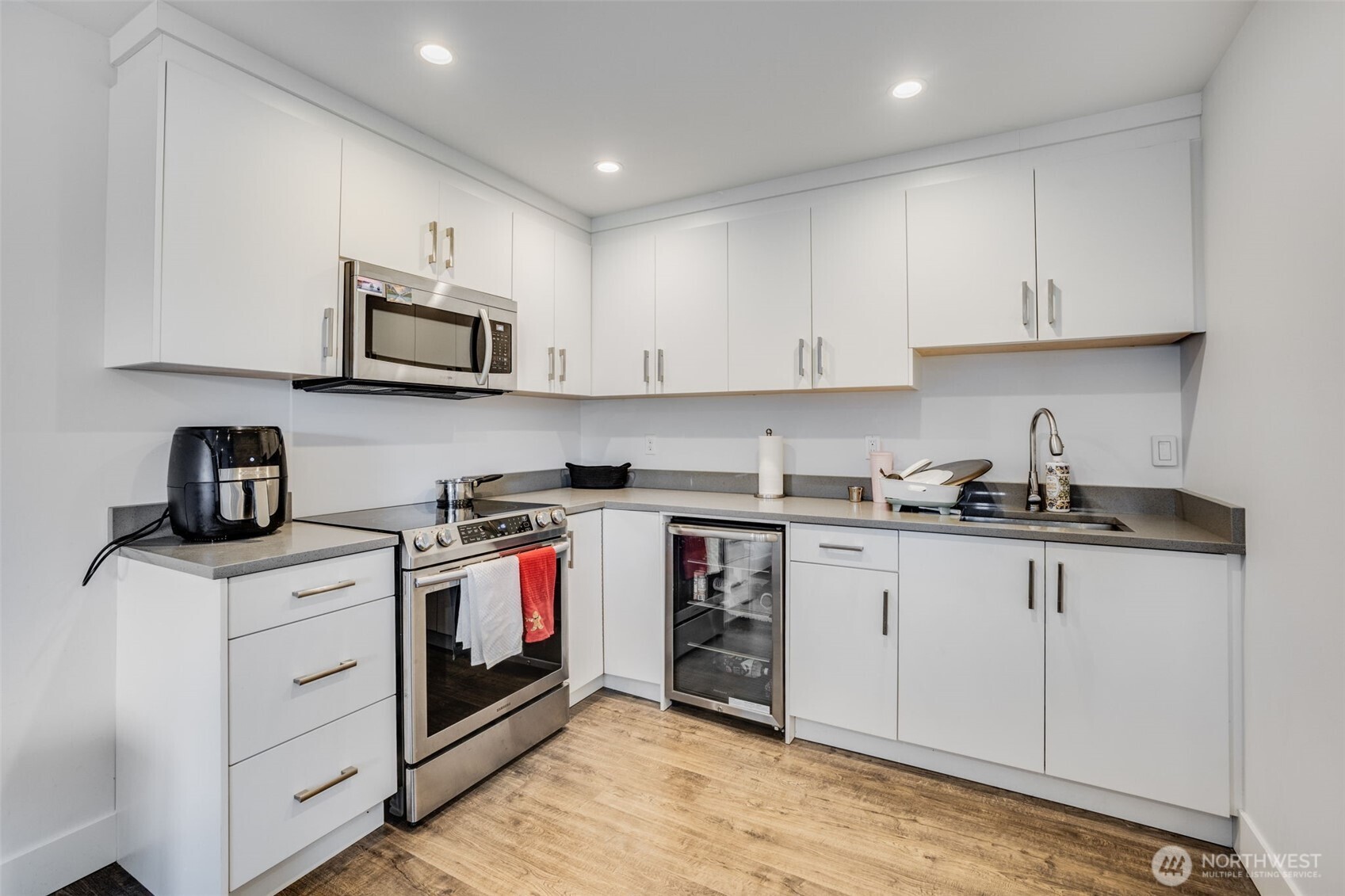 17323 Military Road South SeaTac, WA 98188 - Photo 32 of 40 a kitchen with stainless steel appliances granite countertop a sink a stove and a microwave