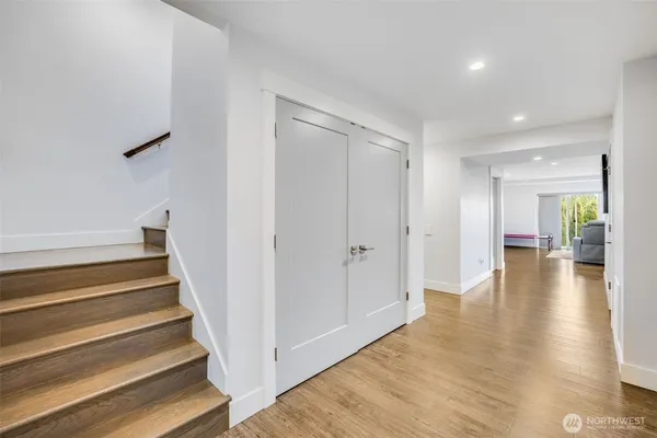 a view of a hallway view with wooden floor and staircase