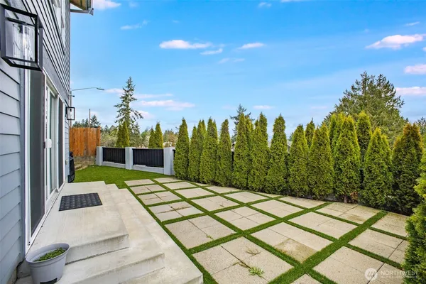a view of a backyard with sitting area