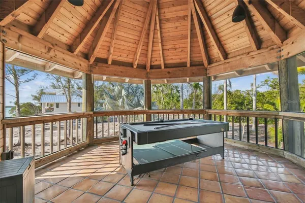 a view of a dinning table and chairs in the deck of the house