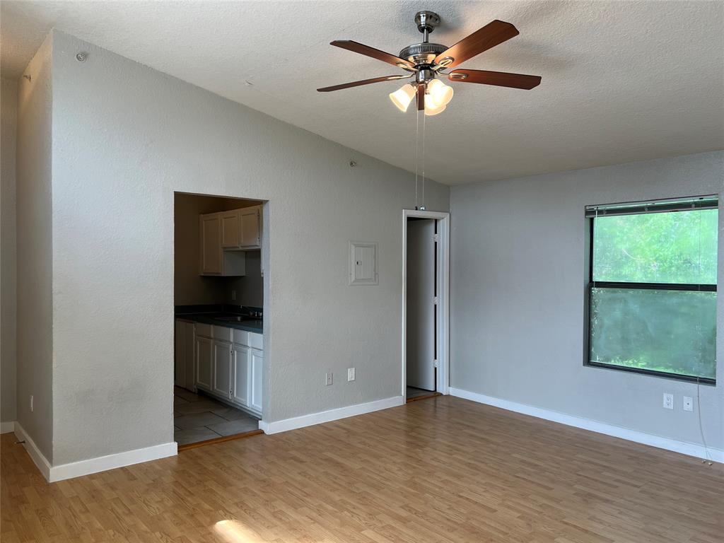 701 West Sycamore Street, Unit 303 Denton, TX 76201 - Photo 4 of 12 This view of the living room shows the accessibility to the kitchen. Notice the large window.