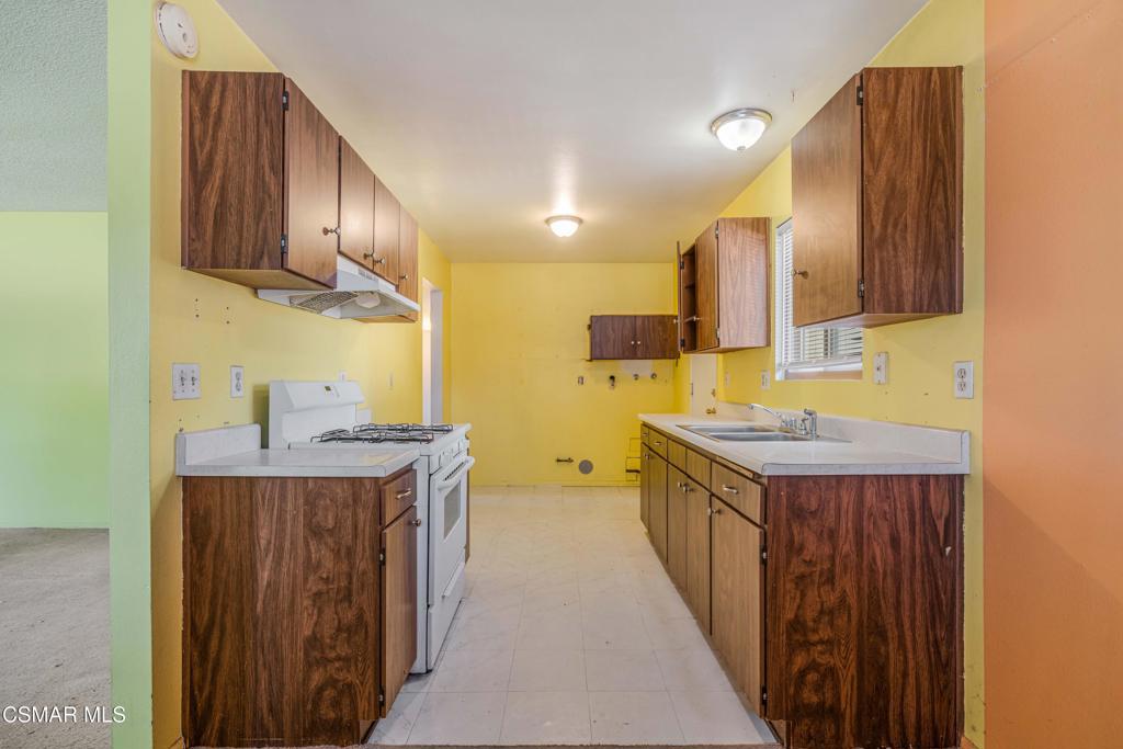 1421 Sequoia Avenue Simi Valley, CA 93063 - Photo 7 of 18 a kitchen with stainless steel appliances a sink stove and cabinets