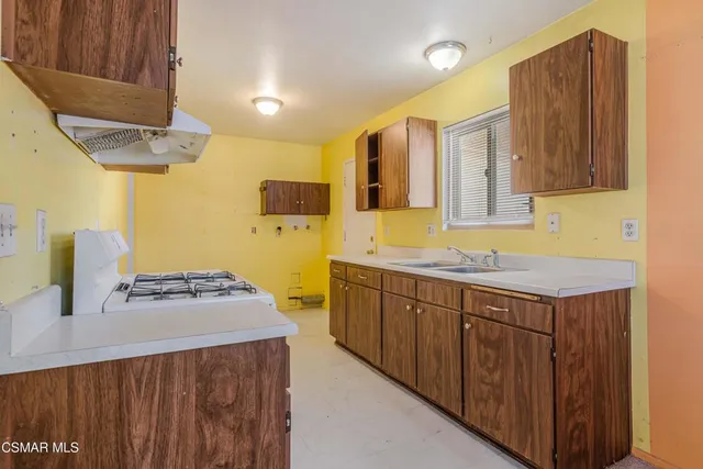 a kitchen with a sink stove and cabinets
