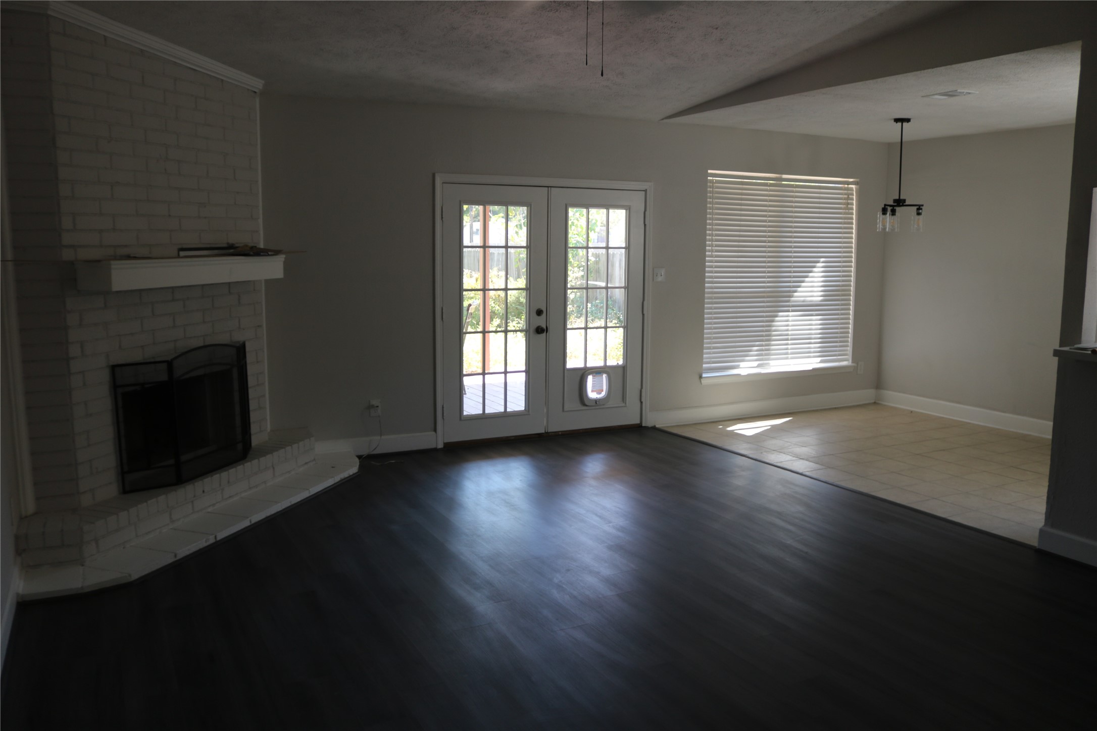 4018 Easy Street Dickinson, TX 77539 - Photo 2 of 11 an empty room with floor to ceiling windows and fireplace