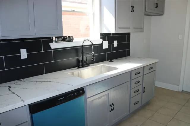 a kitchen with a sink and cabinets