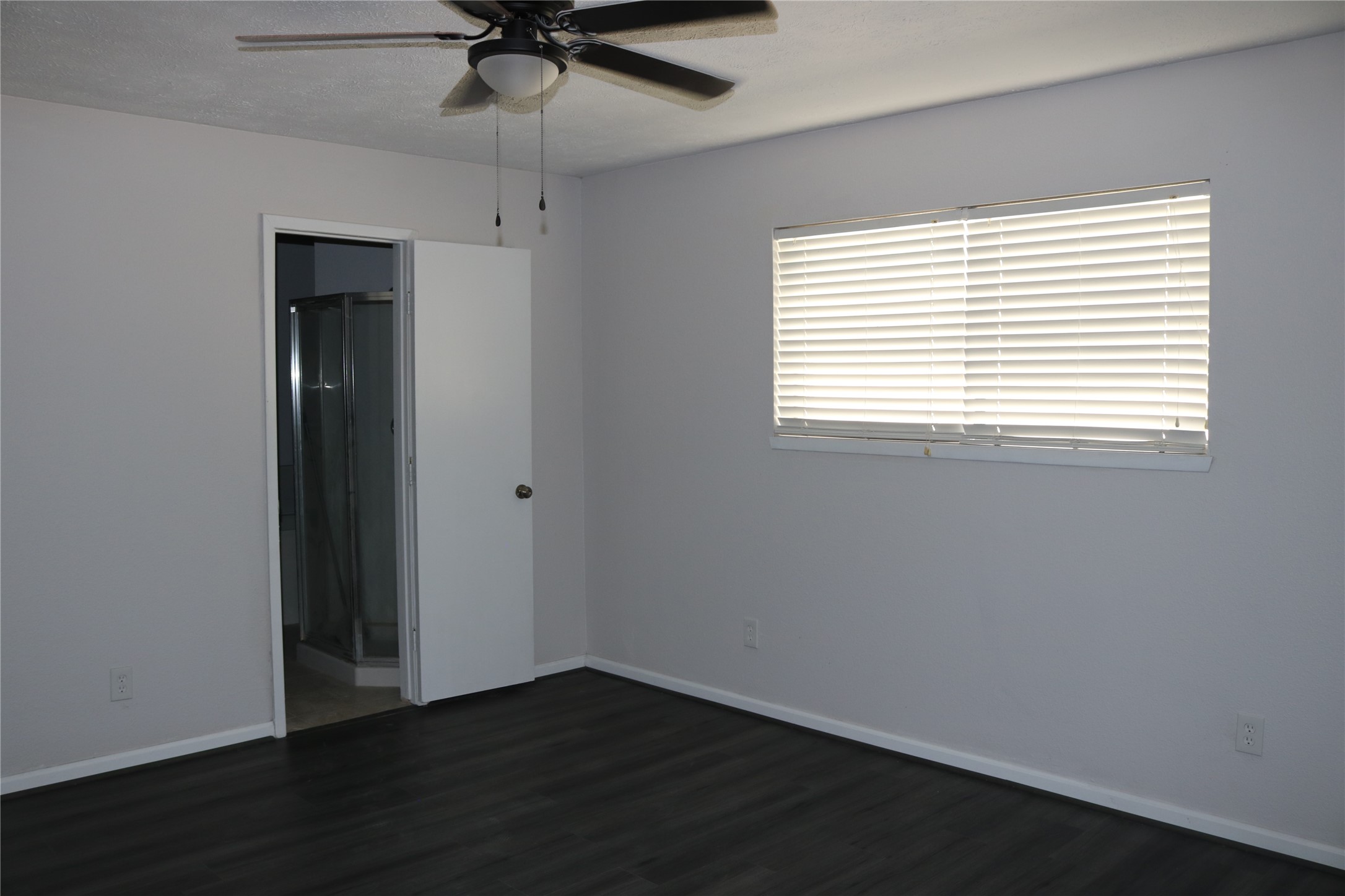 4018 Easy Street Dickinson, TX 77539 - Photo 7 of 11 a view of an empty room with wooden floor and a window