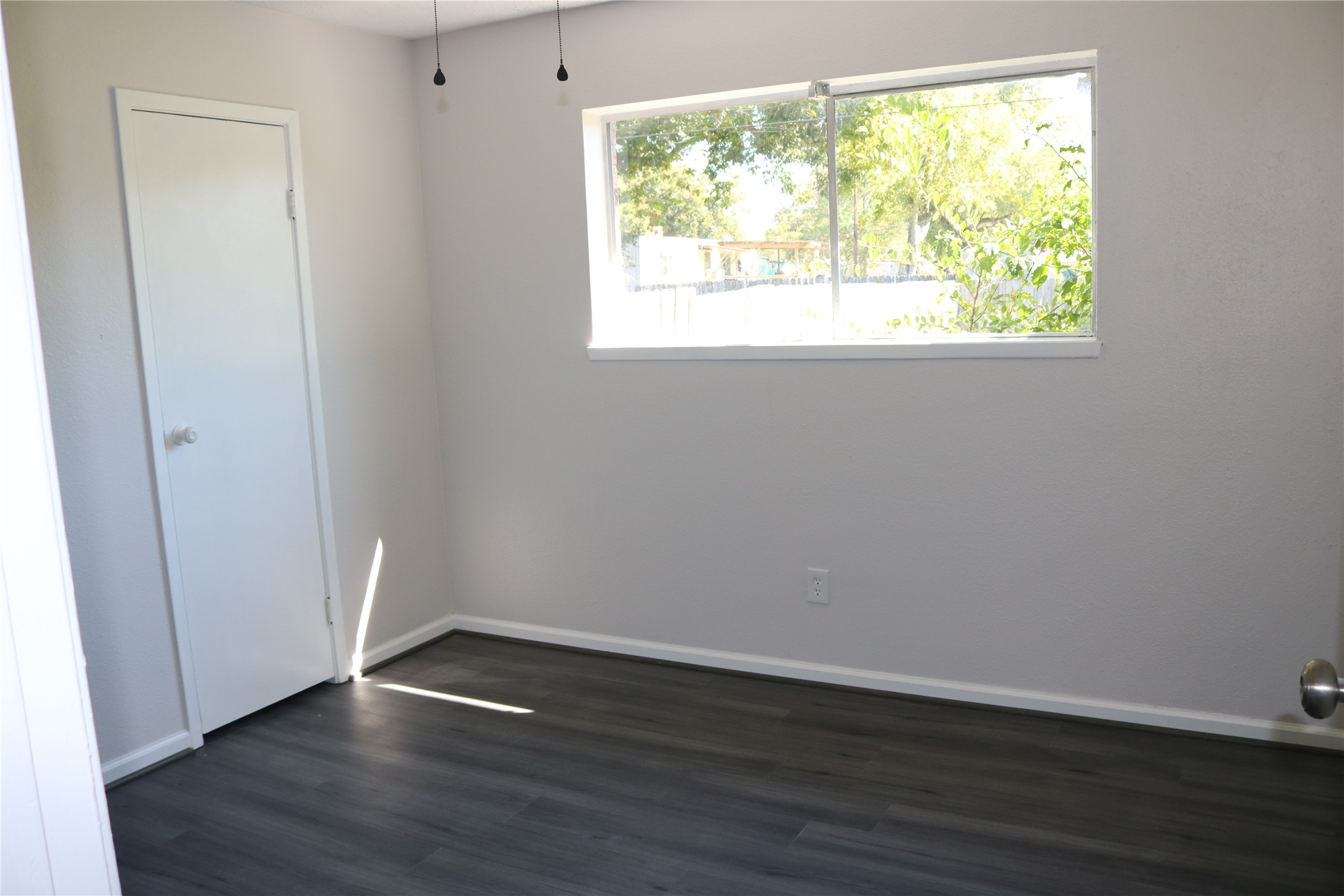 4018 Easy Street Dickinson, TX 77539 - Photo 9 of 11 an empty room with wooden floor and windows