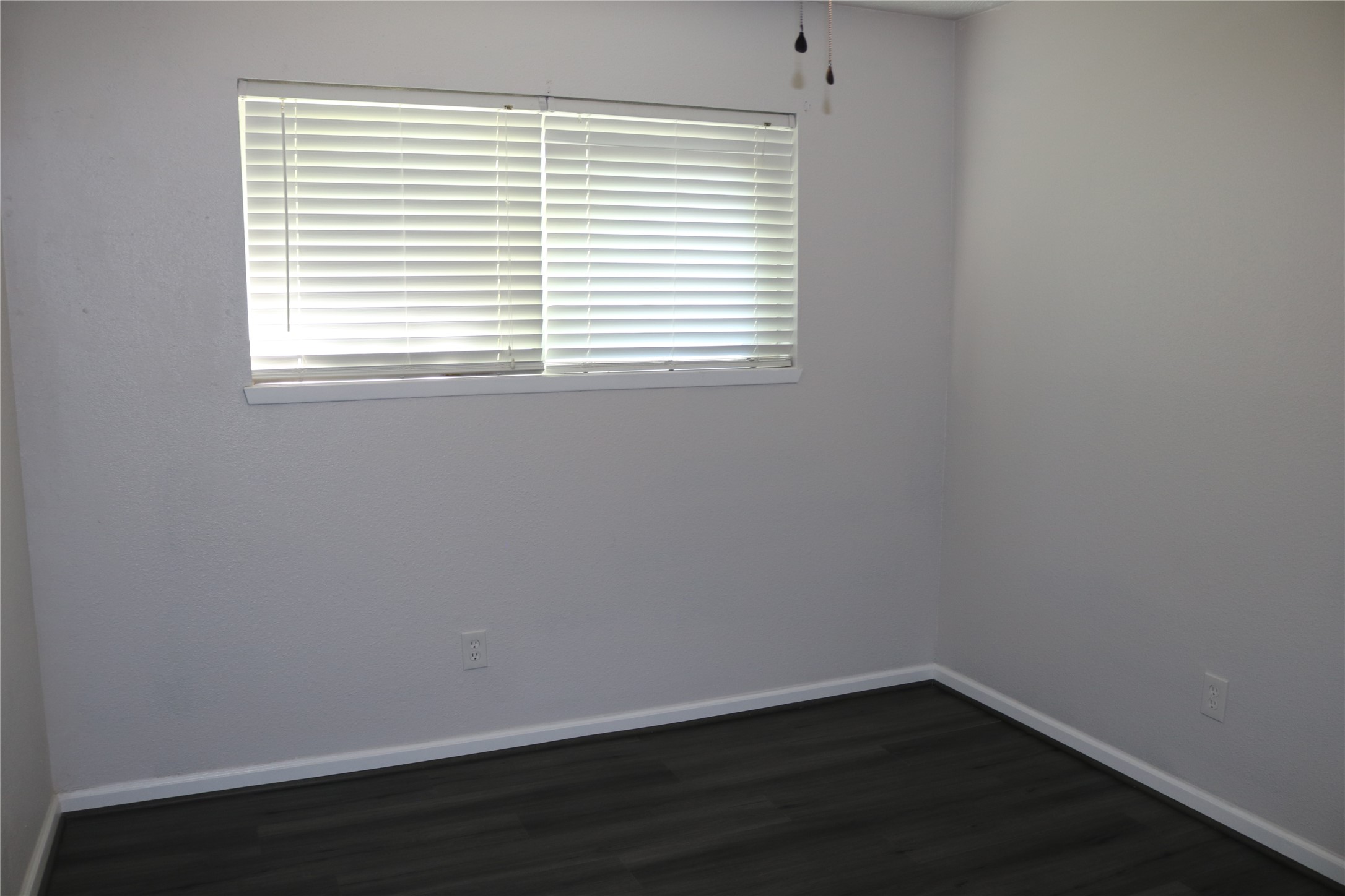 4018 Easy Street Dickinson, TX 77539 - Photo 10 of 11 a view of an empty room with wooden floor and a window