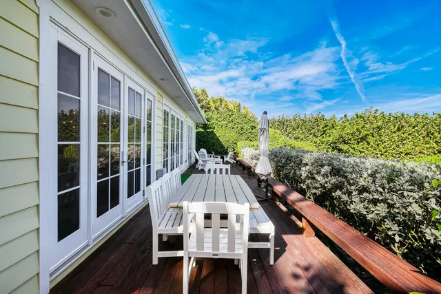 a view of balcony with wooden floor and outdoor seating