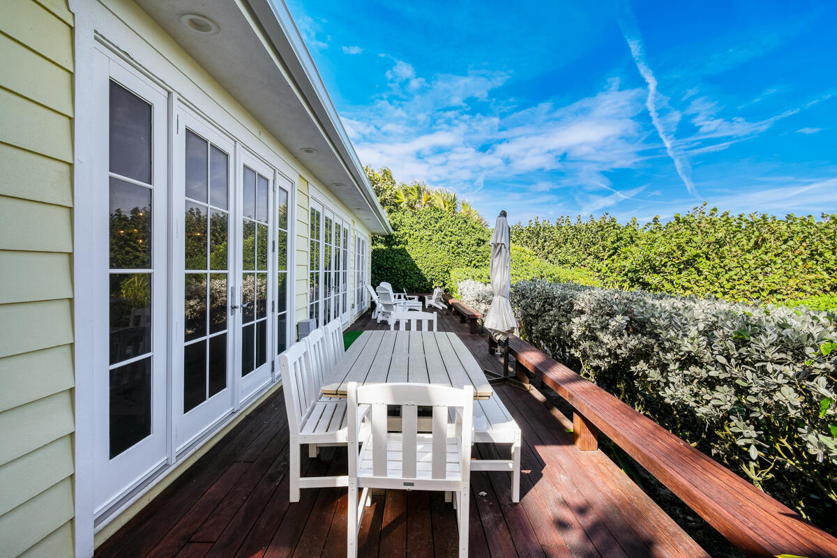 107 North Beach Road Jupiter Island, FL 33455 - Photo 13 of 49 a view of balcony with wooden floor and outdoor seating