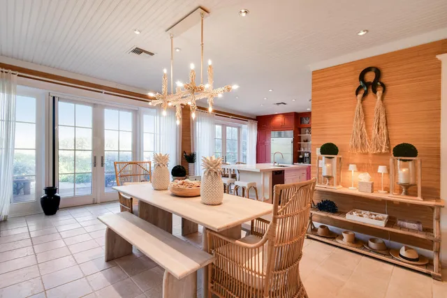 a large white kitchen with a large window