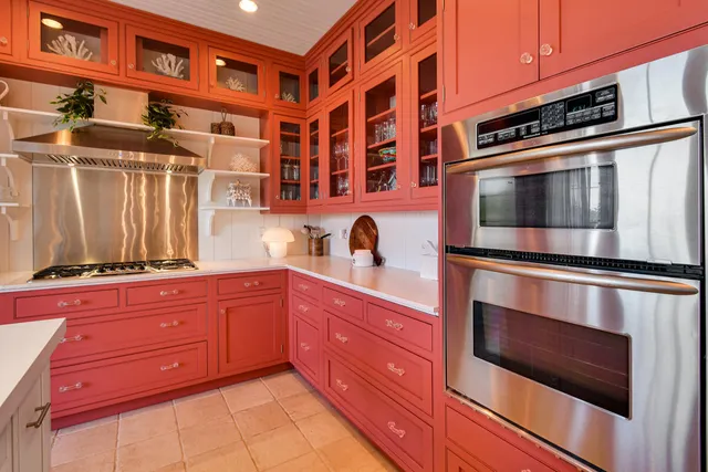a kitchen with stainless steel appliances granite countertop a stove and cabinets