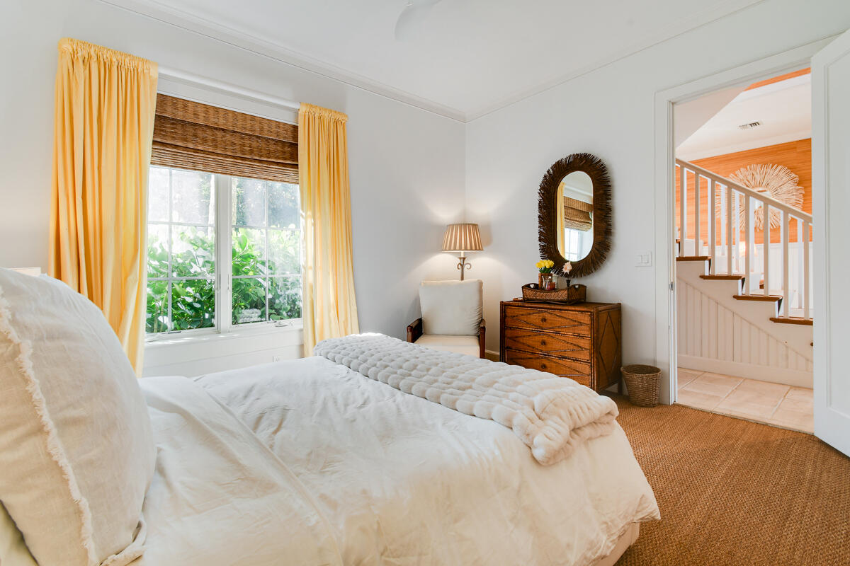 107 North Beach Road Jupiter Island, FL 33455 - Photo 33 of 49 a bedroom with a bed and a large window