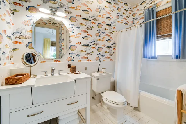 a bathroom with a sink a toilet and a mirror