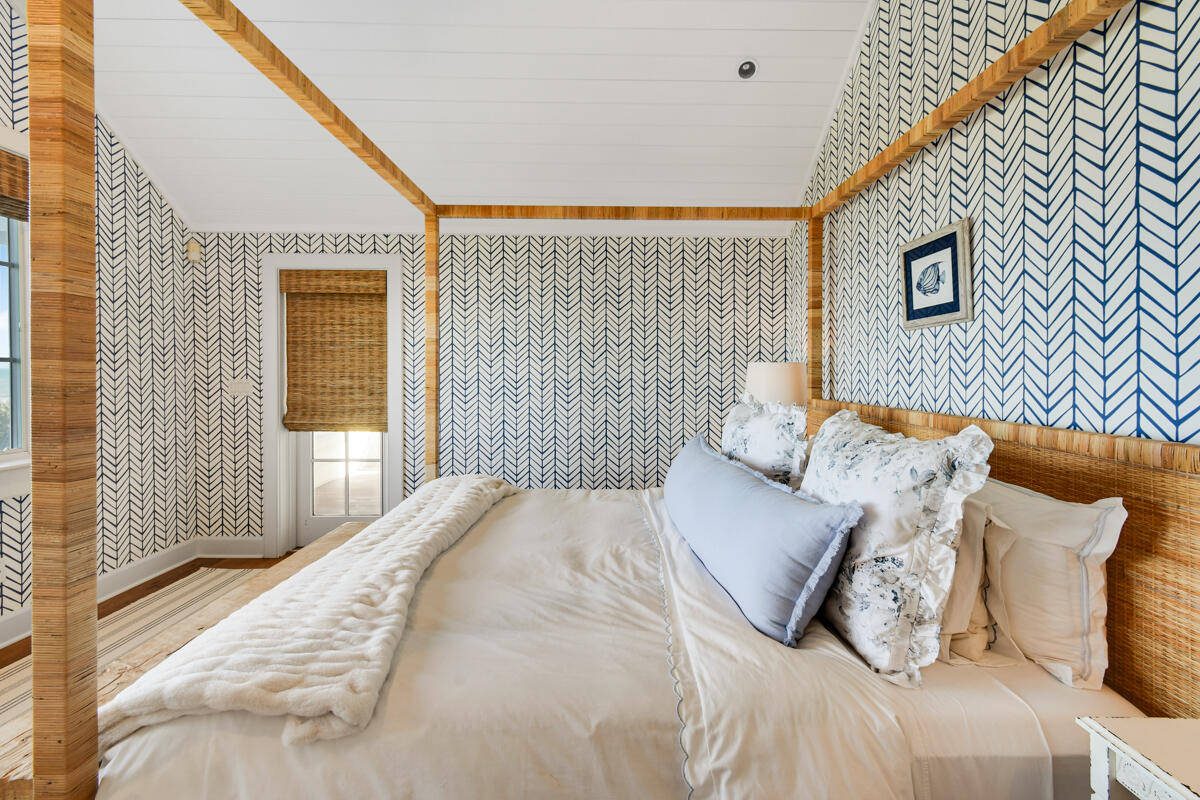 107 North Beach Road Jupiter Island, FL 33455 - Photo 39 of 49 a bedroom with a bed and a large window