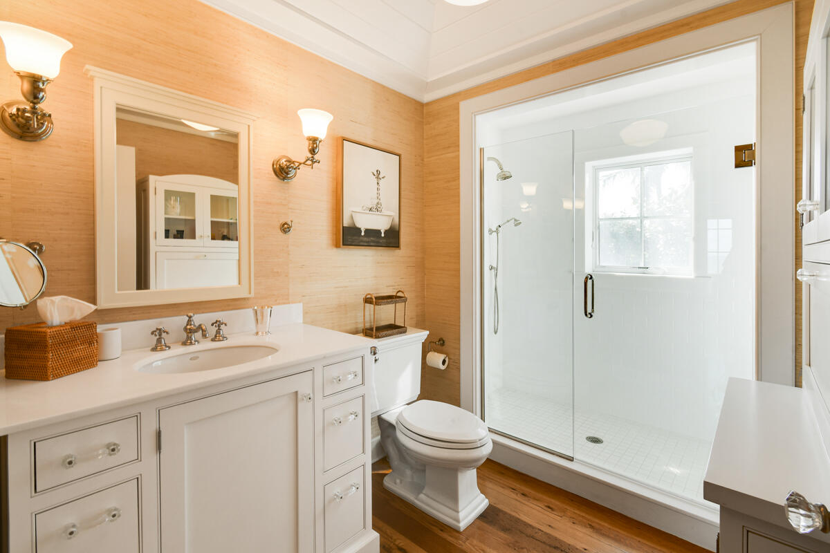 107 North Beach Road Jupiter Island, FL 33455 - Photo 42 of 49 a bathroom with a granite countertop sink toilet a mirror a vanity and shower