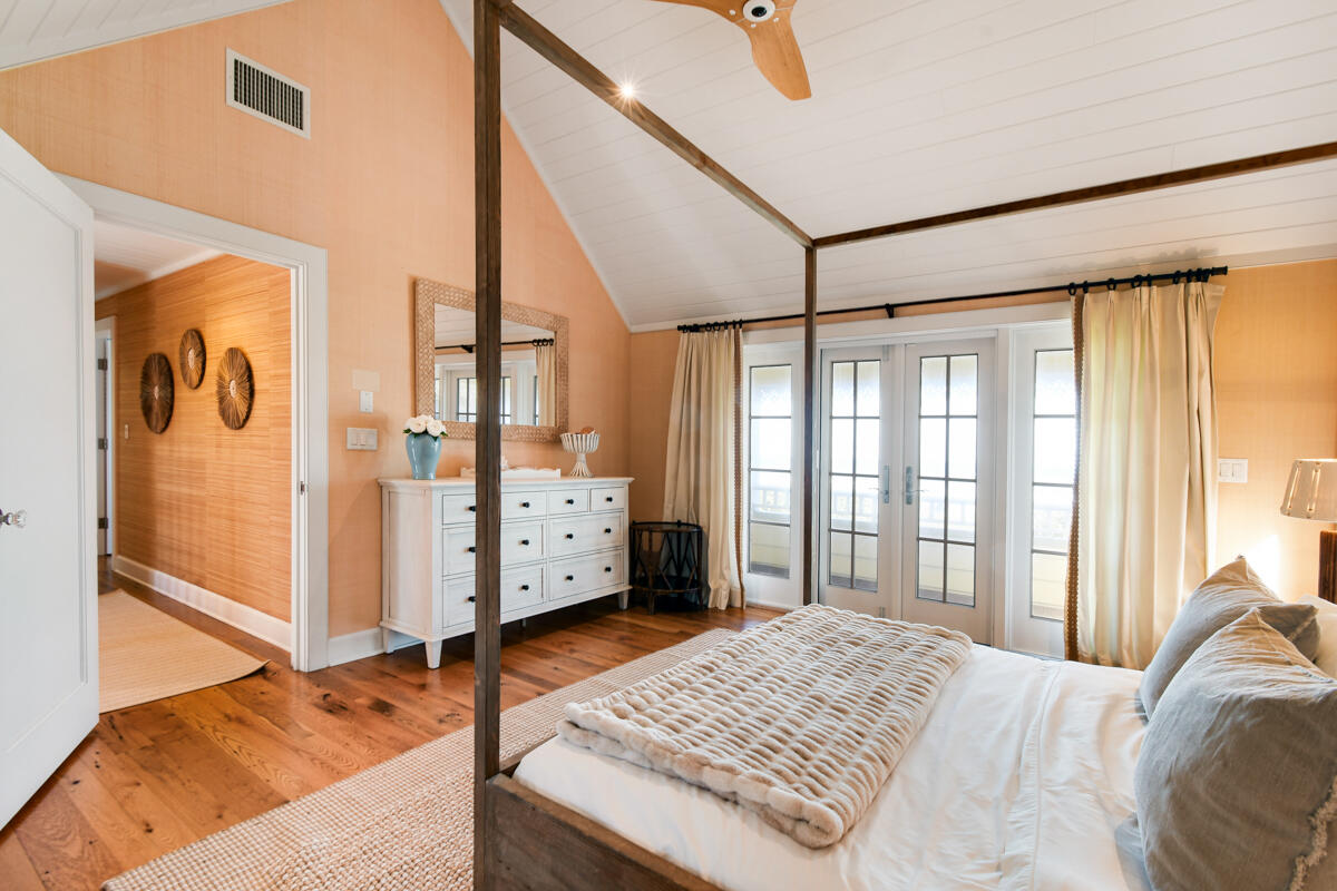 107 North Beach Road Jupiter Island, FL 33455 - Photo 44 of 49 a bedroom with a bed and glass door