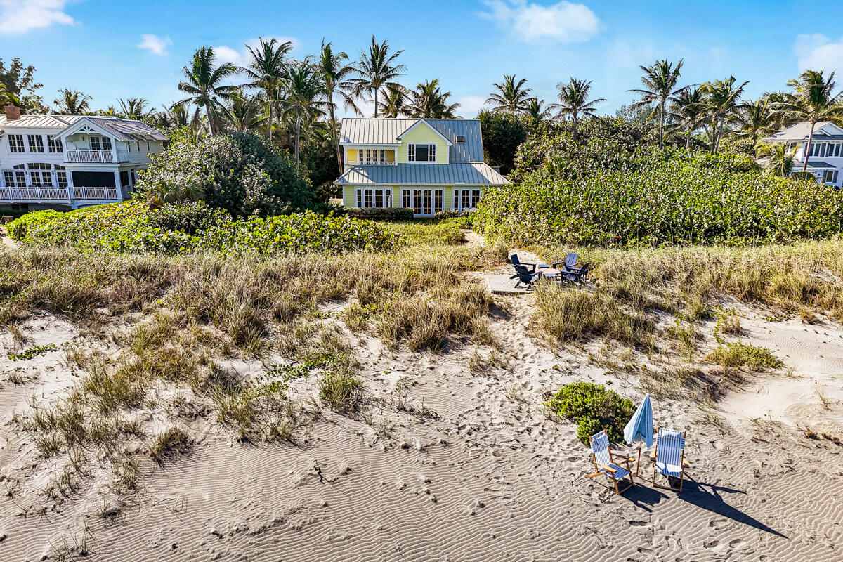 107 North Beach Road Jupiter Island, FL 33455 - Photo 5 of 49 a view of a large garden with a house in the background