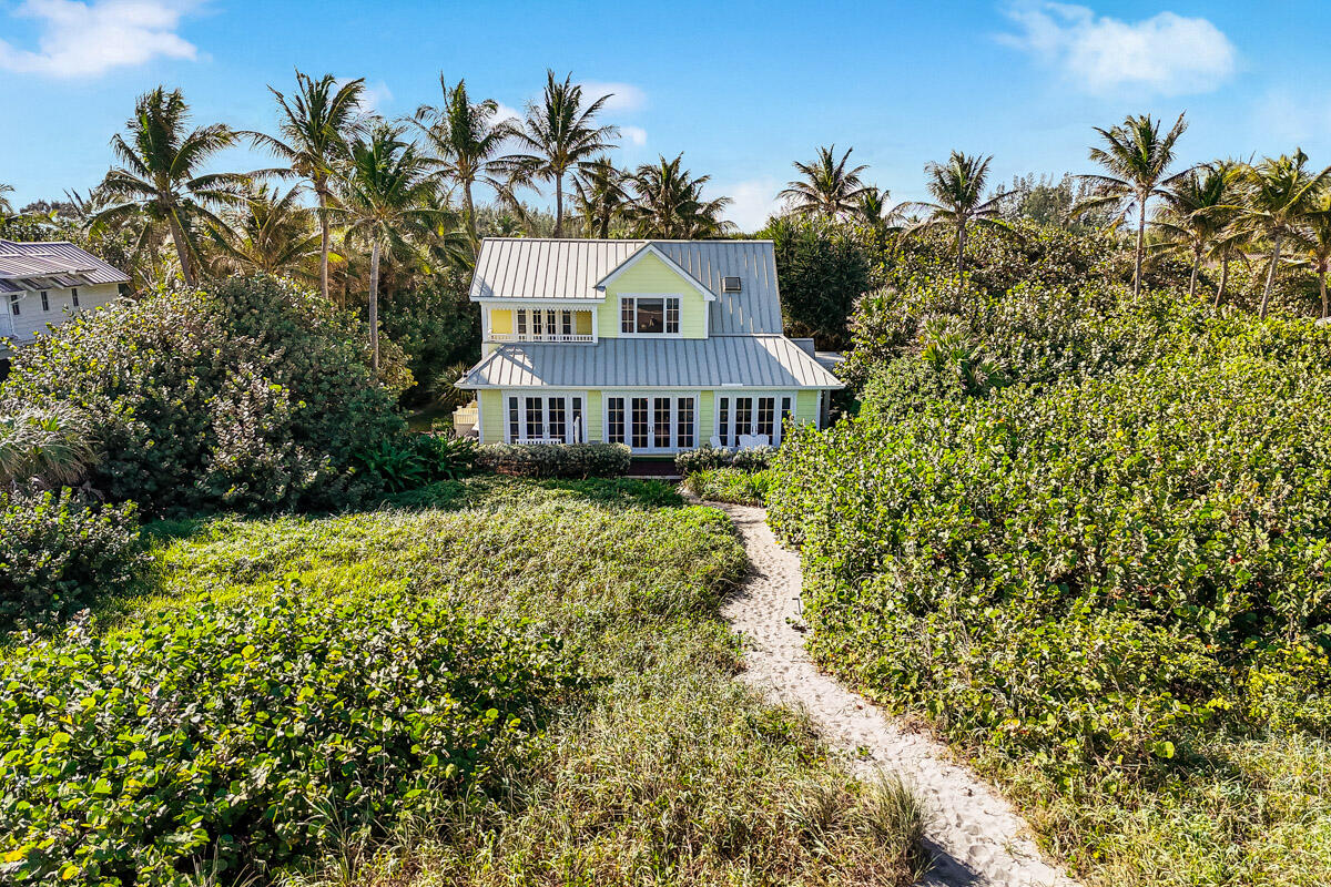 107 North Beach Road Jupiter Island, FL 33455 - Photo 6 of 49 a view of a house with a yard and potted plants