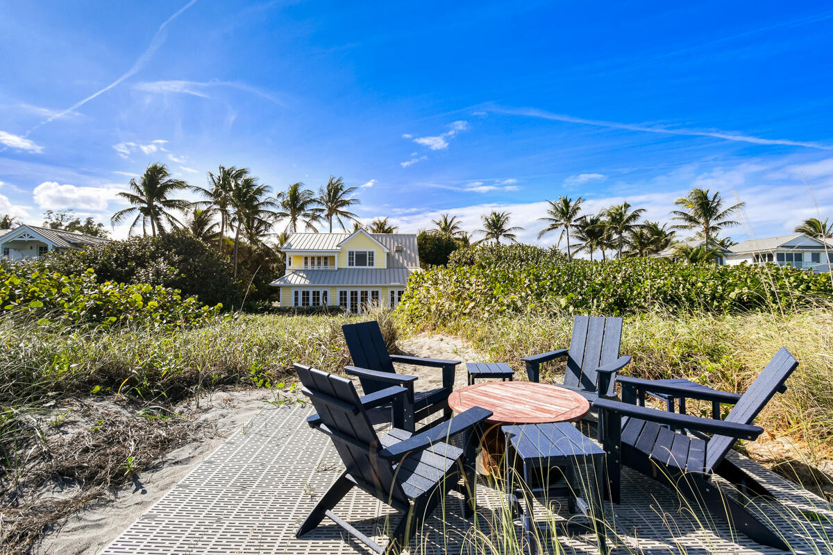 107 North Beach Road Jupiter Island, FL 33455 - Photo 10 of 49 a view of a terrace with furniture and a fire pit