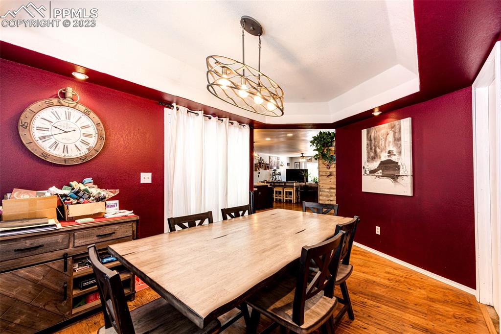 1023 Monument Street Calhan, CO 80808 - Photo 13 of 35 a view of a dining room with furniture and chandelier