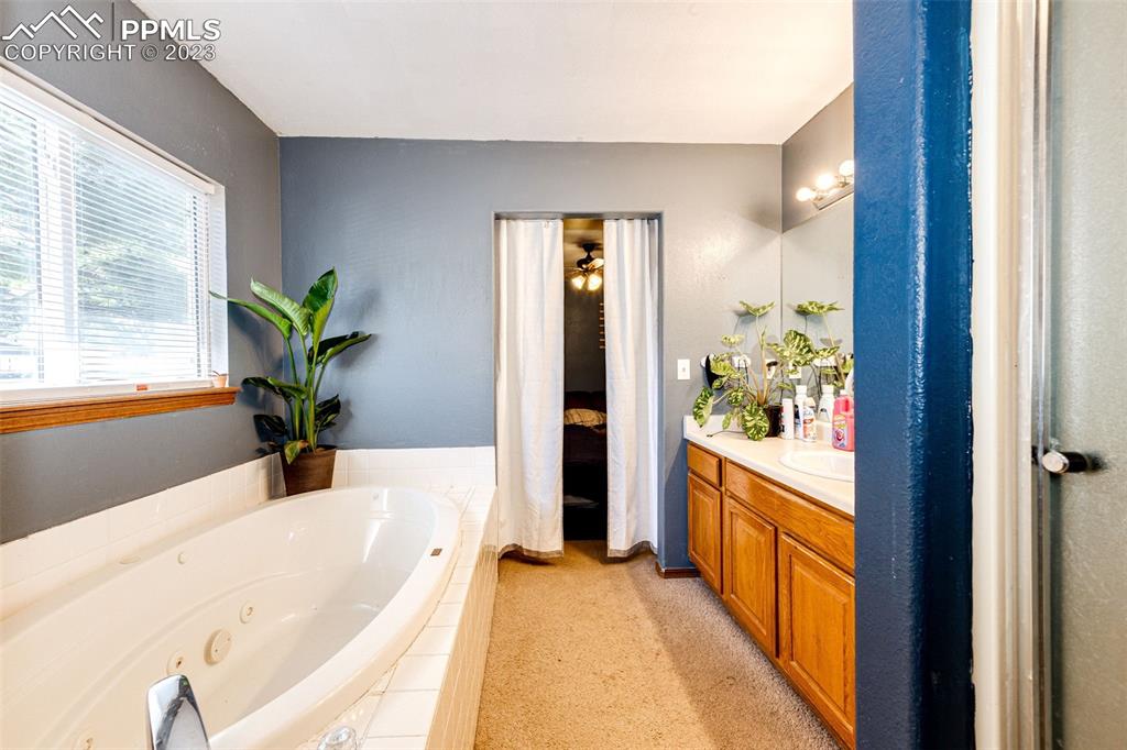 1023 Monument Street Calhan, CO 80808 - Photo 17 of 35 a spacious bathroom with a tub and shower