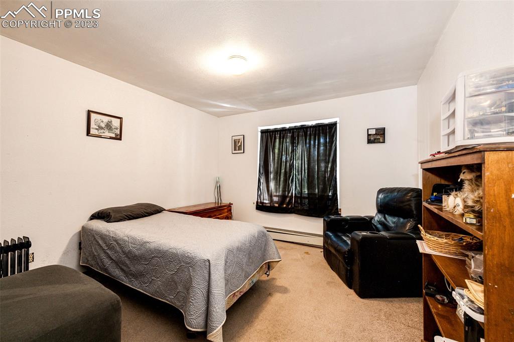 1023 Monument Street Calhan, CO 80808 - Photo 19 of 35 a bedroom with a bed and a couch