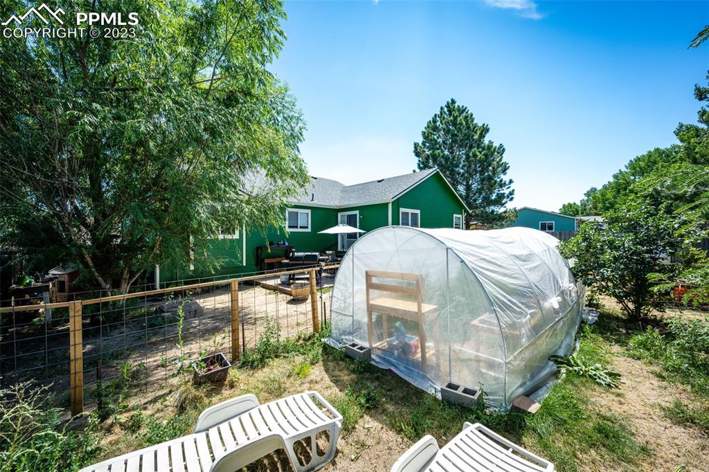 1023 Monument Street Calhan, CO 80808 - Photo 33 of 35 a view of a balcony with chairs and wooden fence