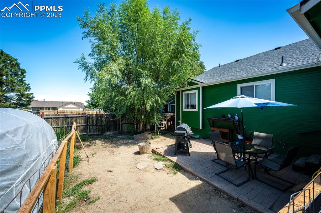 1023 Monument Street Calhan, CO 80808 - Photo 34 of 35 a view of a patio with a table chairs and a barbeque