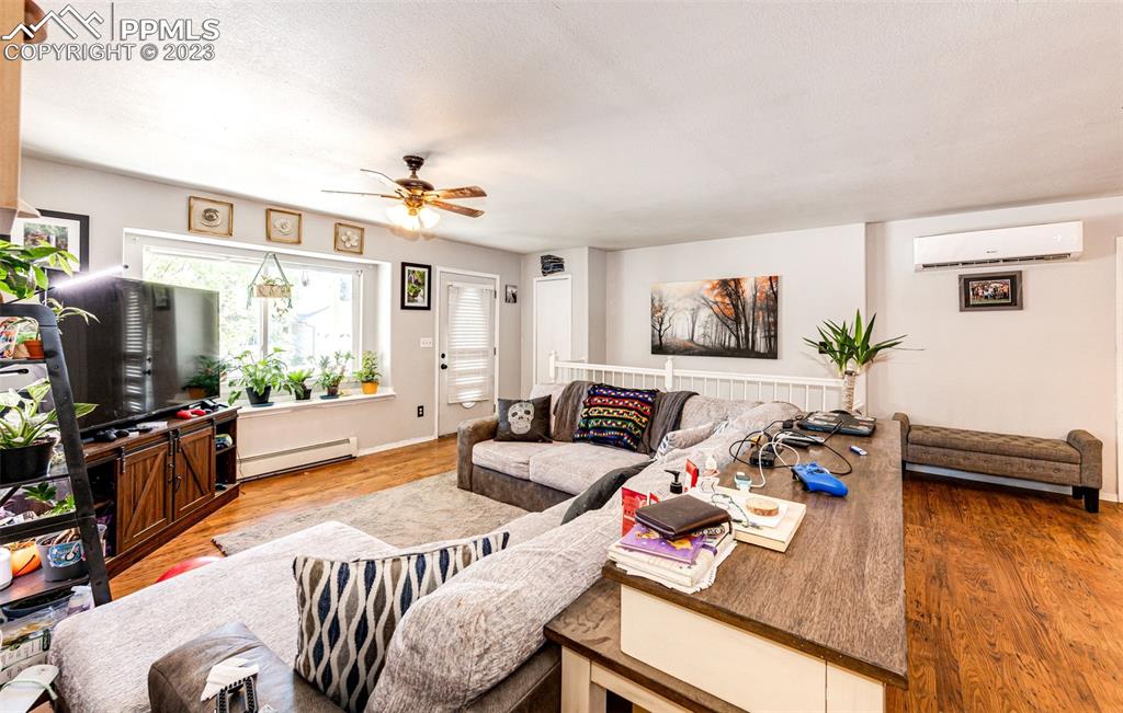 1023 Monument Street Calhan, CO 80808 - Photo 7 of 35 a living room with furniture and a flat screen tv