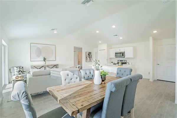 a living room with furniture and view of kitchen