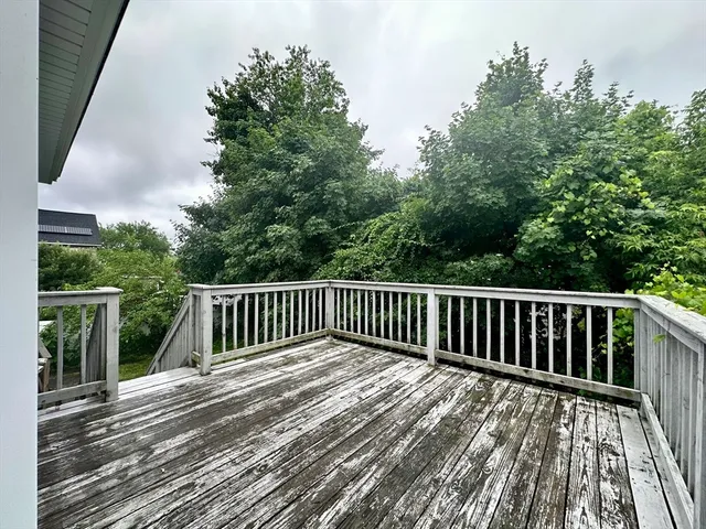 a view of balcony with wooden floor and fence