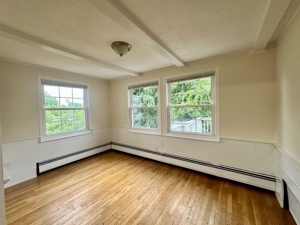 354 University Avenue Lowell, MA 01854 - Photo 4 of 13 a view of an empty room with wooden floor and a window