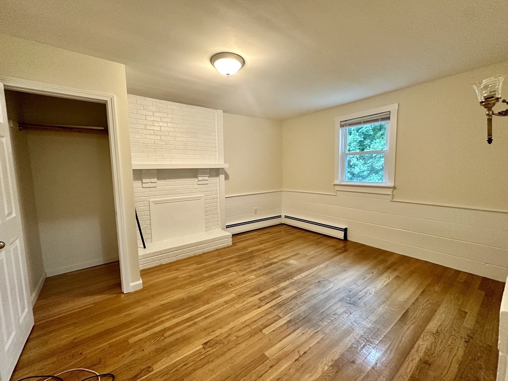 354 University Avenue Lowell, MA 01854 - Photo 5 of 13 an empty room with wooden floor and windows