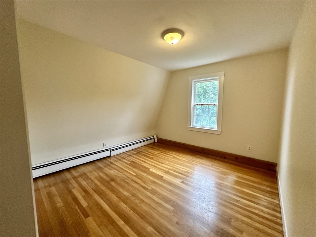 354 University Avenue Lowell, MA 01854 - Photo 10 of 13 a view of an empty room with wooden floor and a window